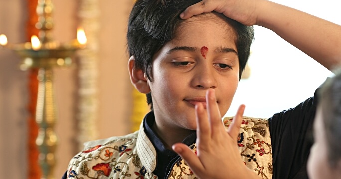 Applying Tika or Raksha Bandhan